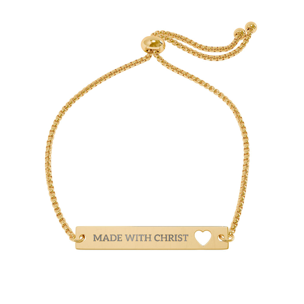 Gold engravable heart bar bracelet with "Made With Christ" inscription, adjustable accessory, featuring a sleek and elegant design.